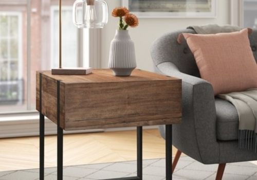 two dumplings on a wood plate with chopsticks